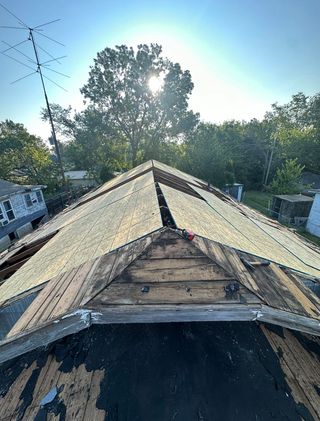 new shningled roof in progress for a house